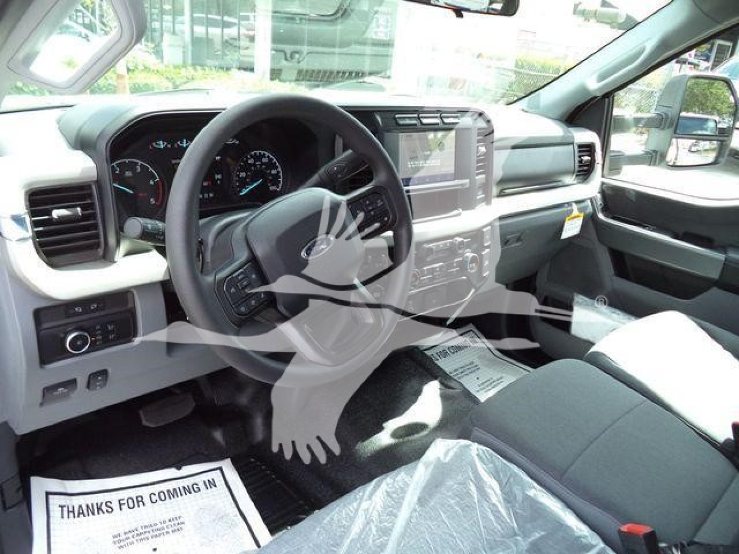 Ford F-550 interior dashboard and steering wheel with touchscreen display and instrument cluster.
