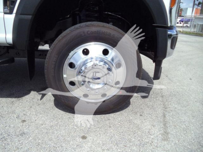 Ford F-550 wheel and front suspension with chrome hubcap and ContiHSP tire, underbody visible.