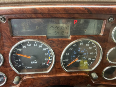 Mack CV713 dashboard showing tachometer and speedometer gauges with central digital display and red P indicator.