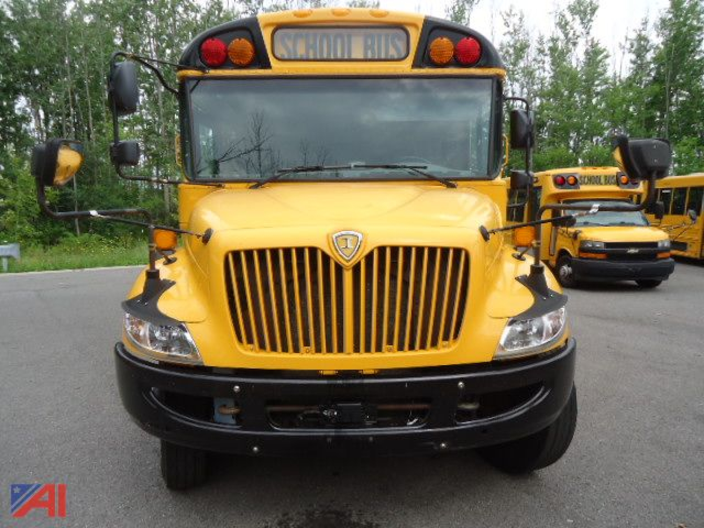 Front view of a yellow 2021 IC Corporation CE Series school bus showing bold grille, headlights, and 'SCHOOL BUS' sign on top.
