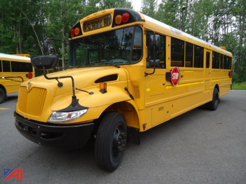 IC Corporation CE Series school bus in yellow, side view with stop sign extended, front engine area and black bumper visible.