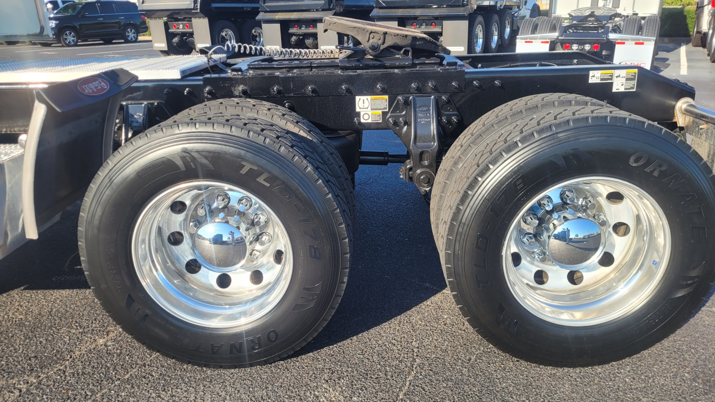 Peterbilt 579 chassis with dual rear axles showing tires and chrome wheels; visible VIN/stock info not shown in image.