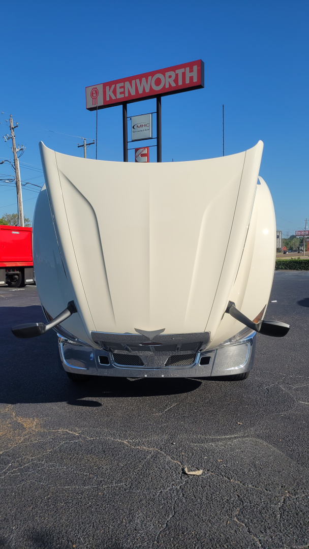 Truck hood front view of a Peterbilt 579 with hood raised, showing the grille and bumper area.
