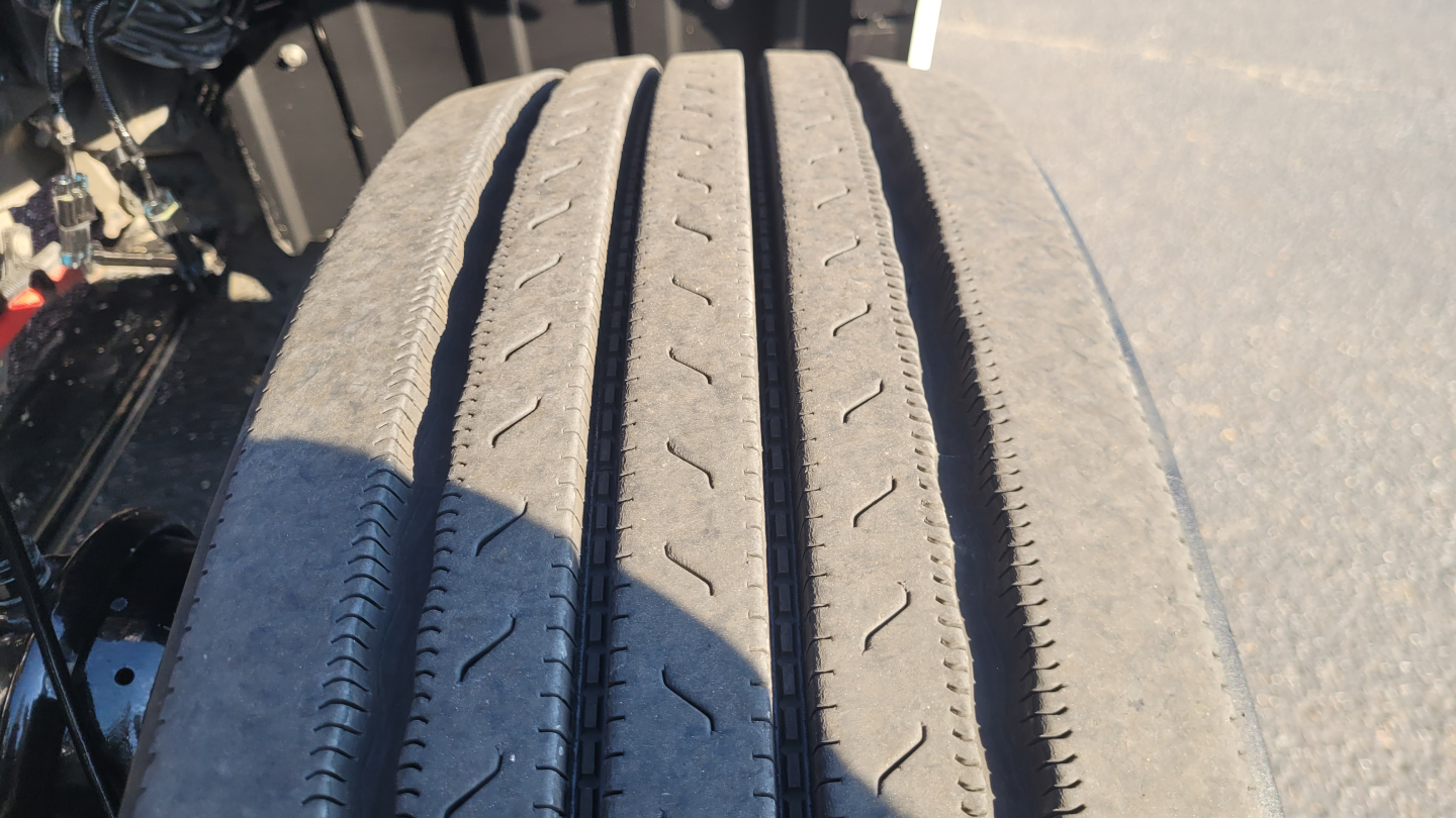 Tire tread close-up on Peterbilt 579 chassis with partial undercarriage visible.