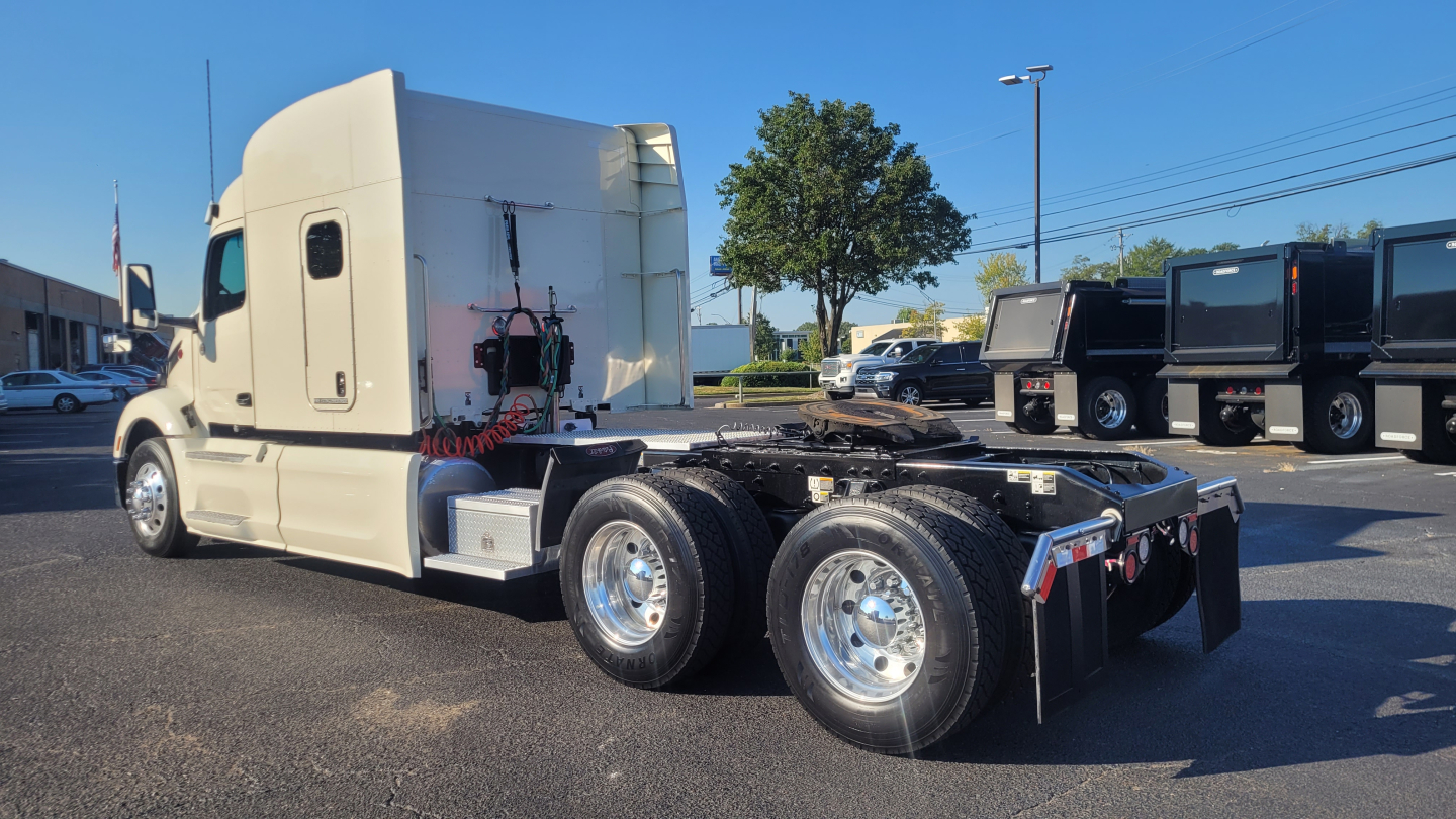 Peterbilt 579 tractor shown from rear-left side, white cab, fifth wheel removed, dual rear axle with polished chrome wheels, stock number 0630278, visible exhaust, fuel tanks, and underframe components.