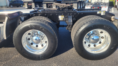 Peterbilt 579 chassis with dual rear axles showing tires and chrome wheels; visible VIN/stock info not shown in image.