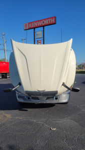 Truck hood front view of a Peterbilt 579 with hood raised, showing the grille and bumper area.