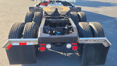 Peterbilt 579 truck rear view showing chassis, dual rear axles, and mud flaps.