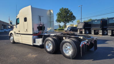Peterbilt 579 tractor shown from rear-left side, white cab, fifth wheel removed, dual rear axle with polished chrome wheels, stock number 0630278, visible exhaust, fuel tanks, and underframe components.