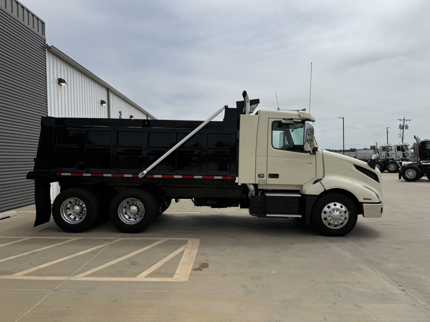 Volvo VNL300 dump truck side view showing loading bed and chassis components.