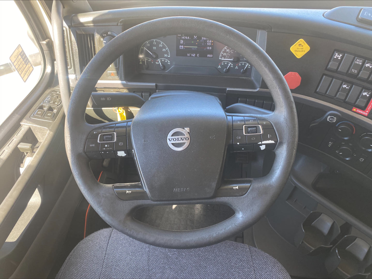Volvo VNL300 truck cabin steering wheel and dashboard with Volvo emblem and control stalks.