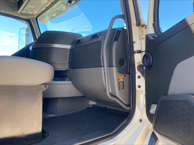 Cab interior of a 2021 Volvo VNL300 truck showing driver's seat, dashboard, and open door with VIN and stock info visible in the listing context.