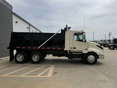 Volvo VNL300 dump truck side view showing loading bed and chassis components.