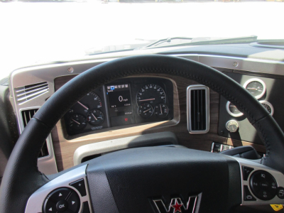 Cab interior of 2027 Western Star 49X showing steering wheel, dashboard with gauges, and infotainment controls.