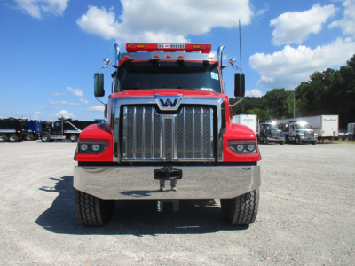 Front view of a new Western Star 49X dump truck showing chrome grille, bumper, and headlights.