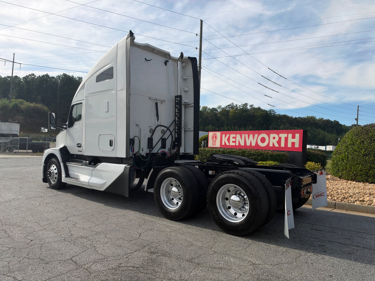 Kenworth T680 truck chassis and sleeper cab side with Kenworth sign on trailer bed and several labels on the cab, no other visible text.