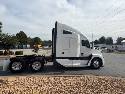 Kenworth T680 conventional sleeper tractor in profile view showing cab and chassis with side door text and windows.