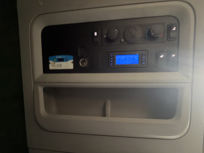 Kenworth T680 dash area with control panel and blue digital display visible