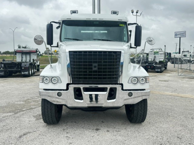 Front view of a white 2020 Volvo VHD roll-off truck with large black grille, dual circular headlights, chrome bumper, and side mirrors