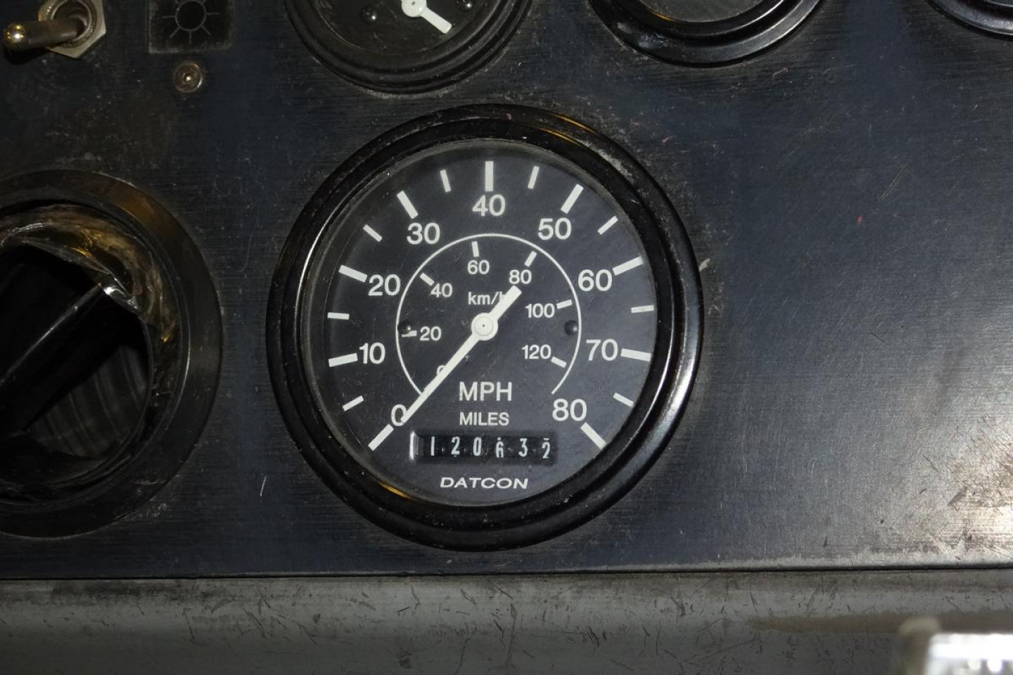 Dashboard gauge cluster with speedometer showing MPH and transmission odometer. Brand: Datcon visible in center.
