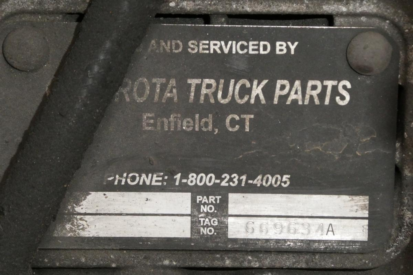 Tag on a truck part reading 'AND SERVICED BY TOYOTA TRUCK PARTS Enfield, CT' with phone number 1-800-231-4005 and a PART NO. tag area.