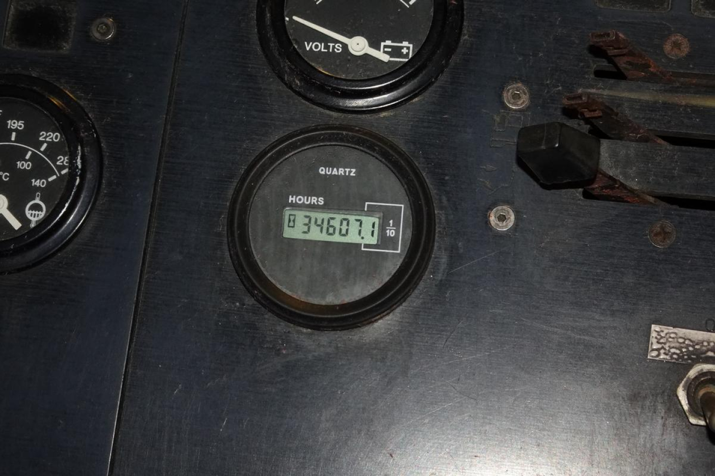 Dashboard panel showing gauges and an elapsed hours meter reading 346.01 hours, with voltmeter and other dials around.