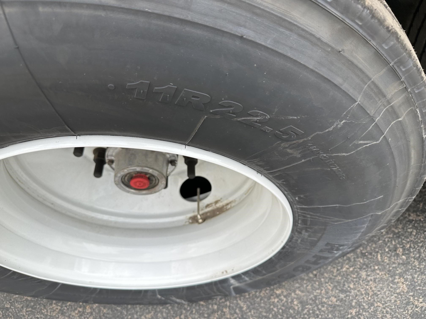 Tire and wheel close-up on a 2027 Timpte hopper trailer showing 11R22.5 tire and white rim.
