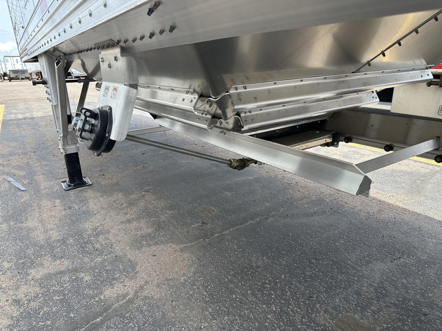 Timpte hopper trailer undercarriage with steel frame, axles, landing gear, and support brackets visible.