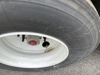 Tire and wheel close-up on a 2027 Timpte hopper trailer showing 11R22.5 tire and white rim.