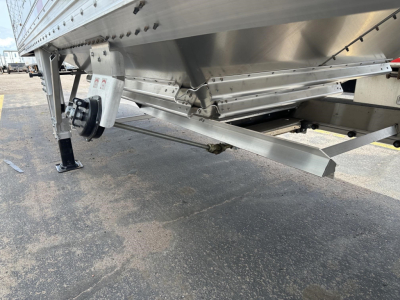 Timpte hopper trailer undercarriage with steel frame, axles, landing gear, and support brackets visible.