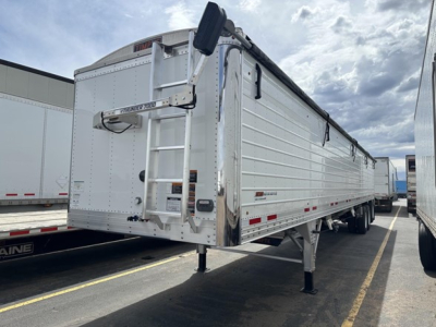 Trailer side view showing Timpte Super Hopper with lift-assist ladder and side panels.