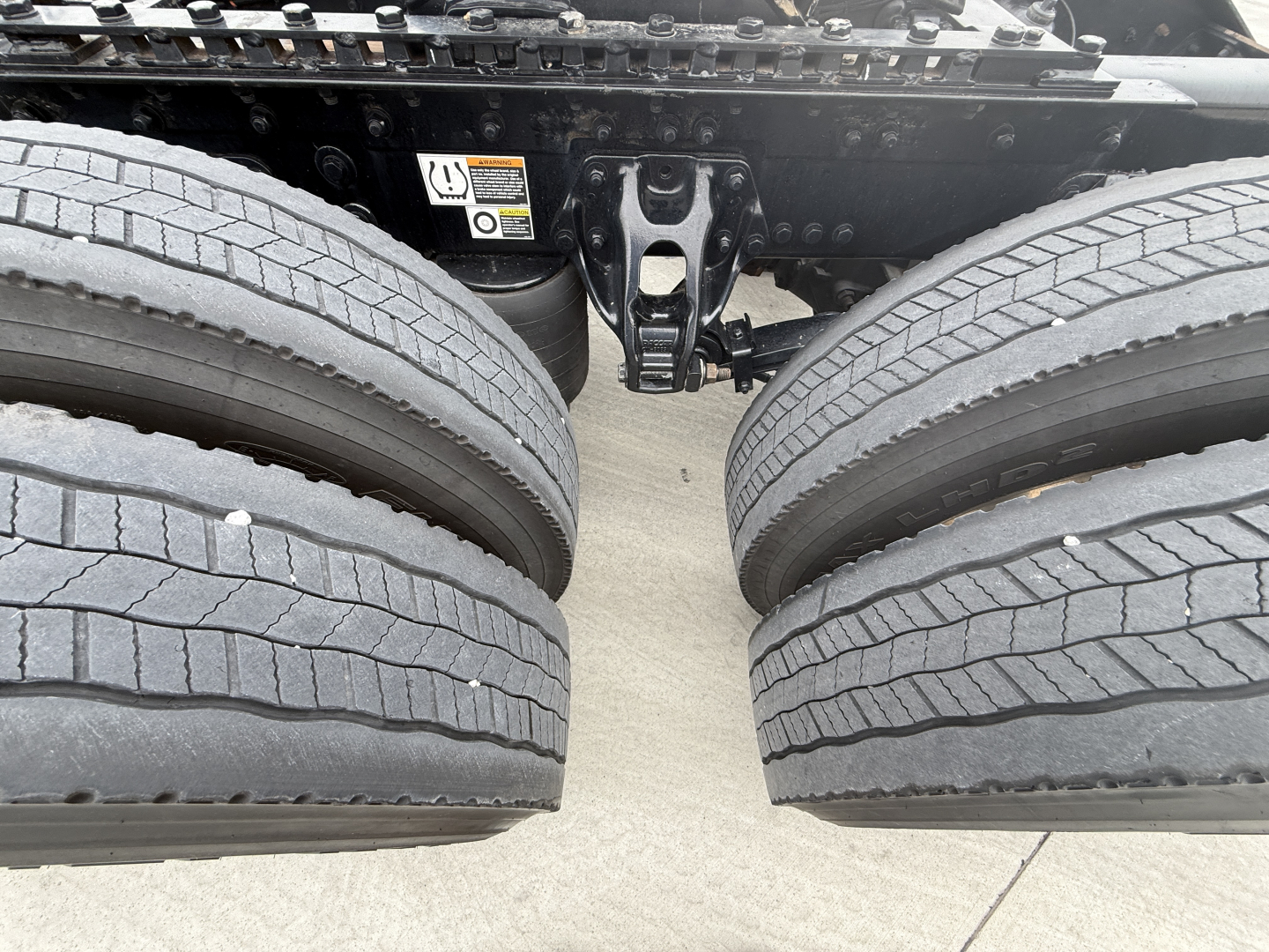 Kenworth W900L chassis with dual rear axles and tires visible