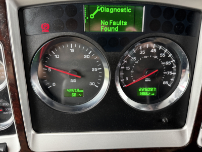 Kenworth W900L instrument cluster showing tachometer and speedometer with digital readouts; Diagnostic display reads 'No Faults Found' in green; odometer and hour meter visible.