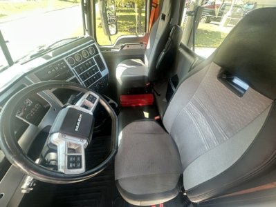 Interior of a 2023 Mack Anthem 64T truck cab showing steering wheel, dashboard, and front seats.