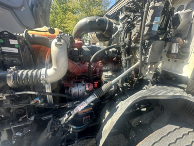 Mack ANTHEM 64T engine bay showing turbocharger and intercooler piping with red engine block and surrounding hoses.