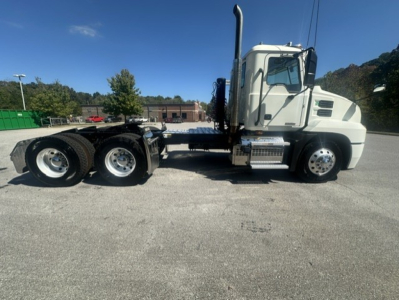 Truck side view showing Mack ANTHEM 64T chassis with dual rear axles and sleeper cab; chrome steps, exhaust stack, fuel tanks visible.