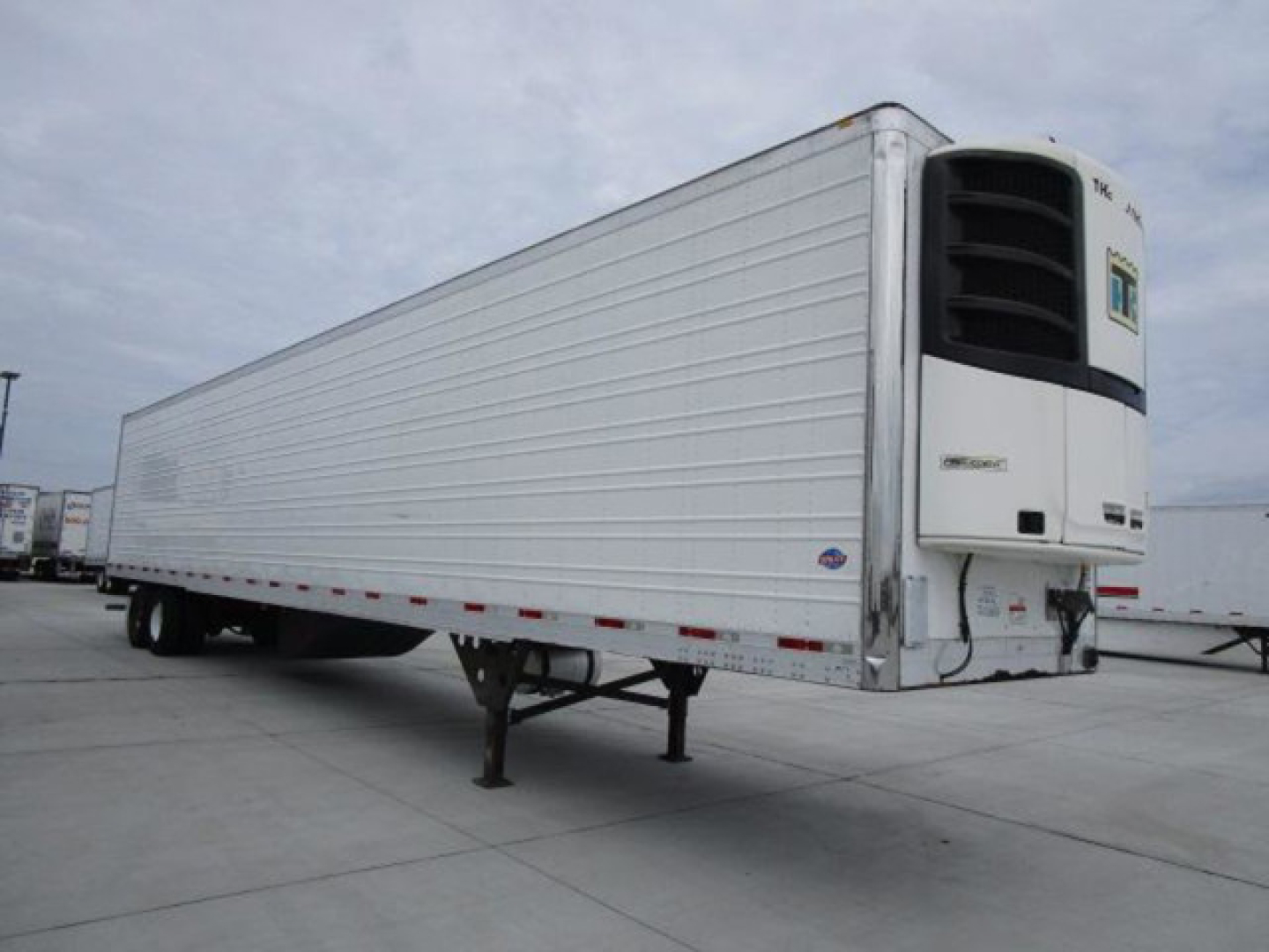 Utility refrigerated trailer with a Thermo King unit showing a white corrugated panel cargo area and front refrigeration unit.