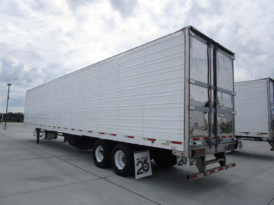 Utility reefer trailer 2019 side and rear view showing tandem wheels and insulated white trailer with doors at back.