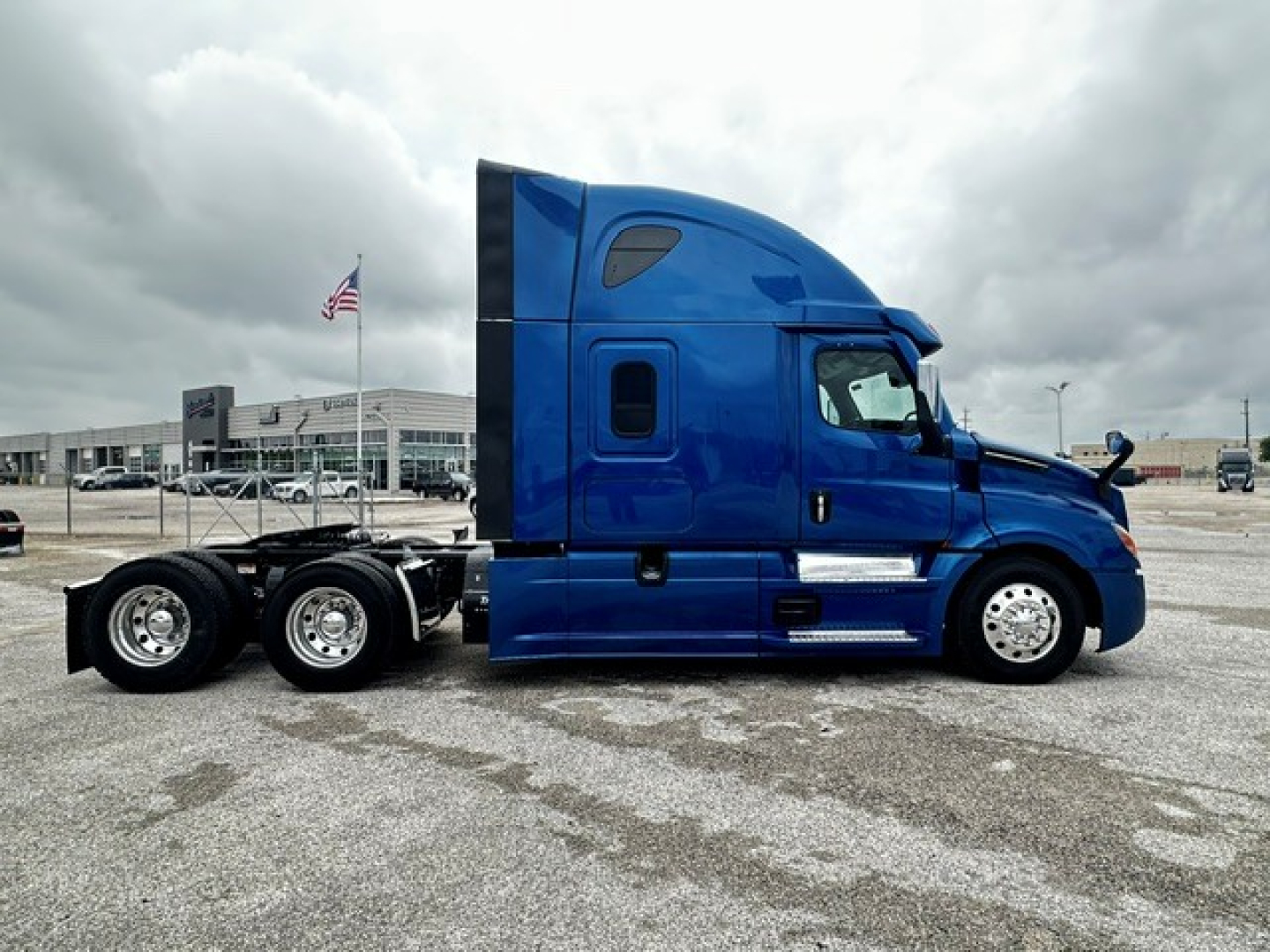 Freightliner Cascadia 126 sleeper truck in blue side view showing exterior cab and dual rear axles.