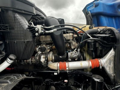 Freightliner Cascadia 126 engine bay showing intercooler pipework and turbocharger components.