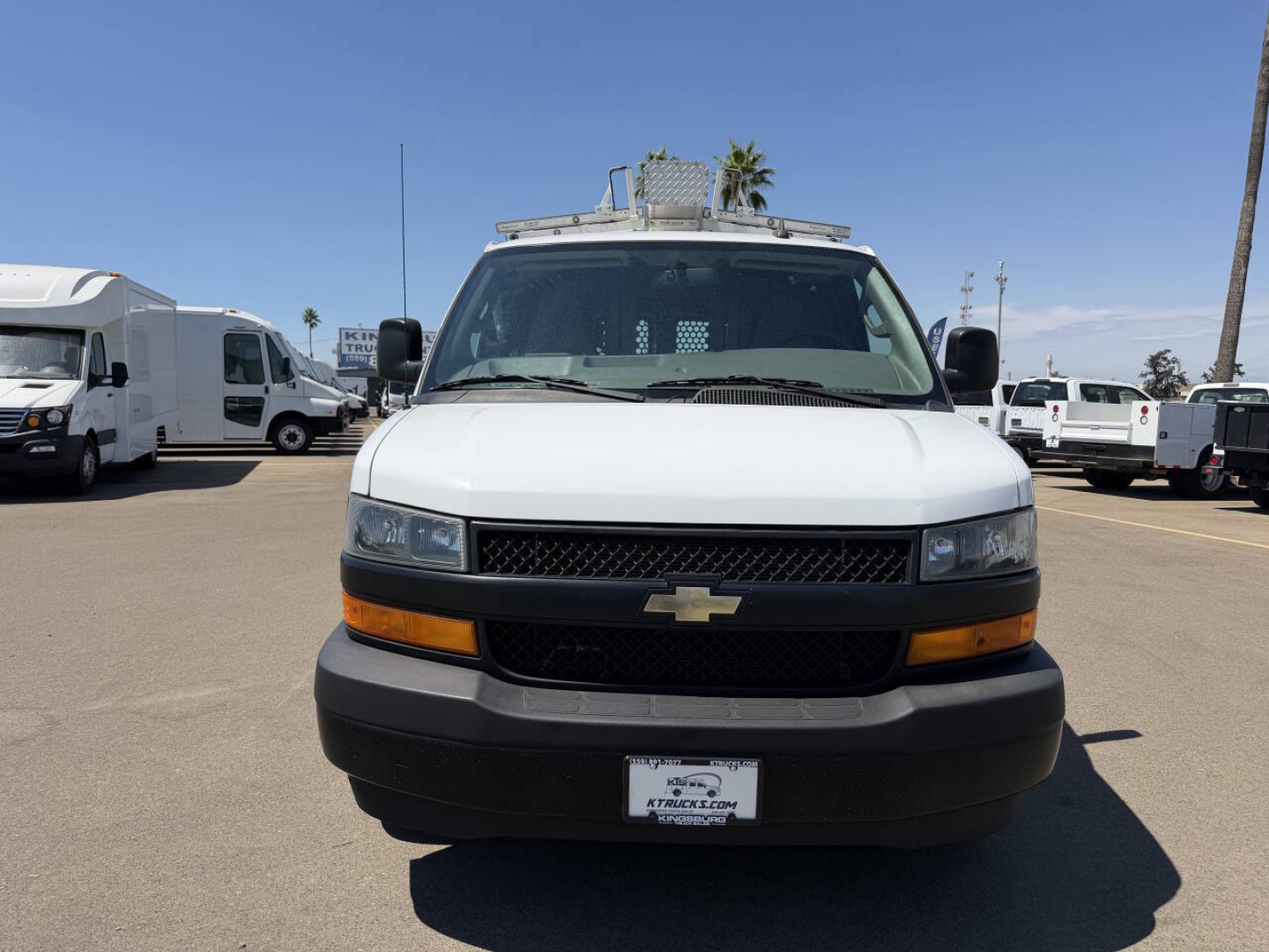 Front view of a white 2022 Chevrolet Express cargo van showing Chevrolet emblem on the grille and black bumper.