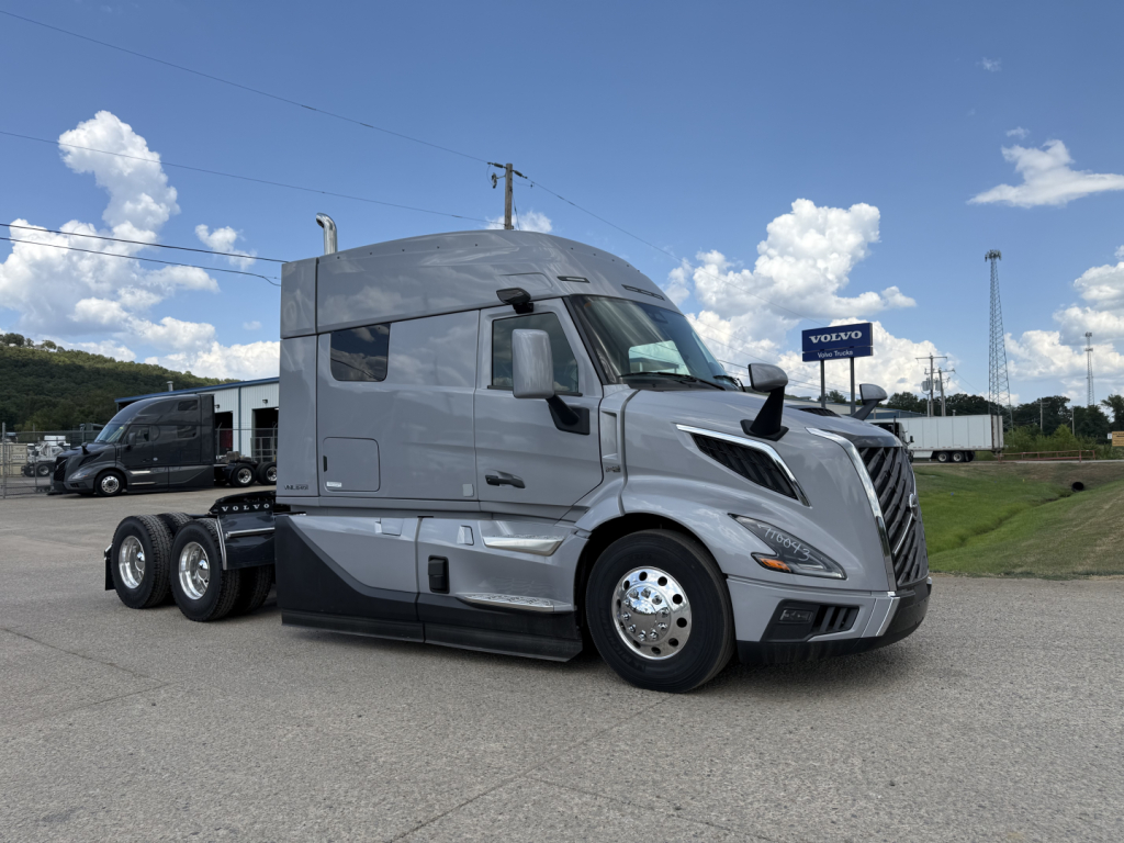 Volvo VNL64T840 semi-truck tractor in light gray, side view showing aerodynamic cab and dual rear axles.