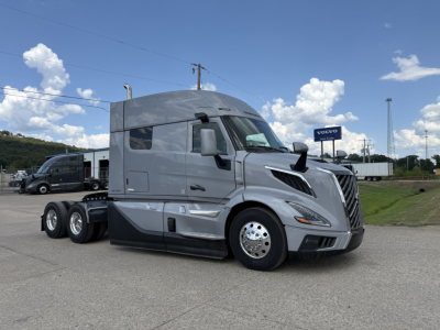 Volvo VNL64T840 semi-truck tractor in light gray, side view showing aerodynamic cab and dual rear axles.