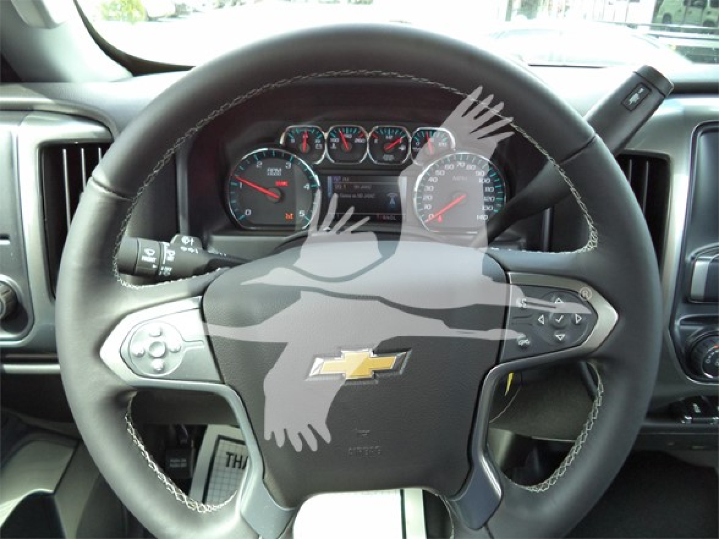 Chevrolet Silverado 6500hd steering wheel and dashboard view with Chevrolet logo center