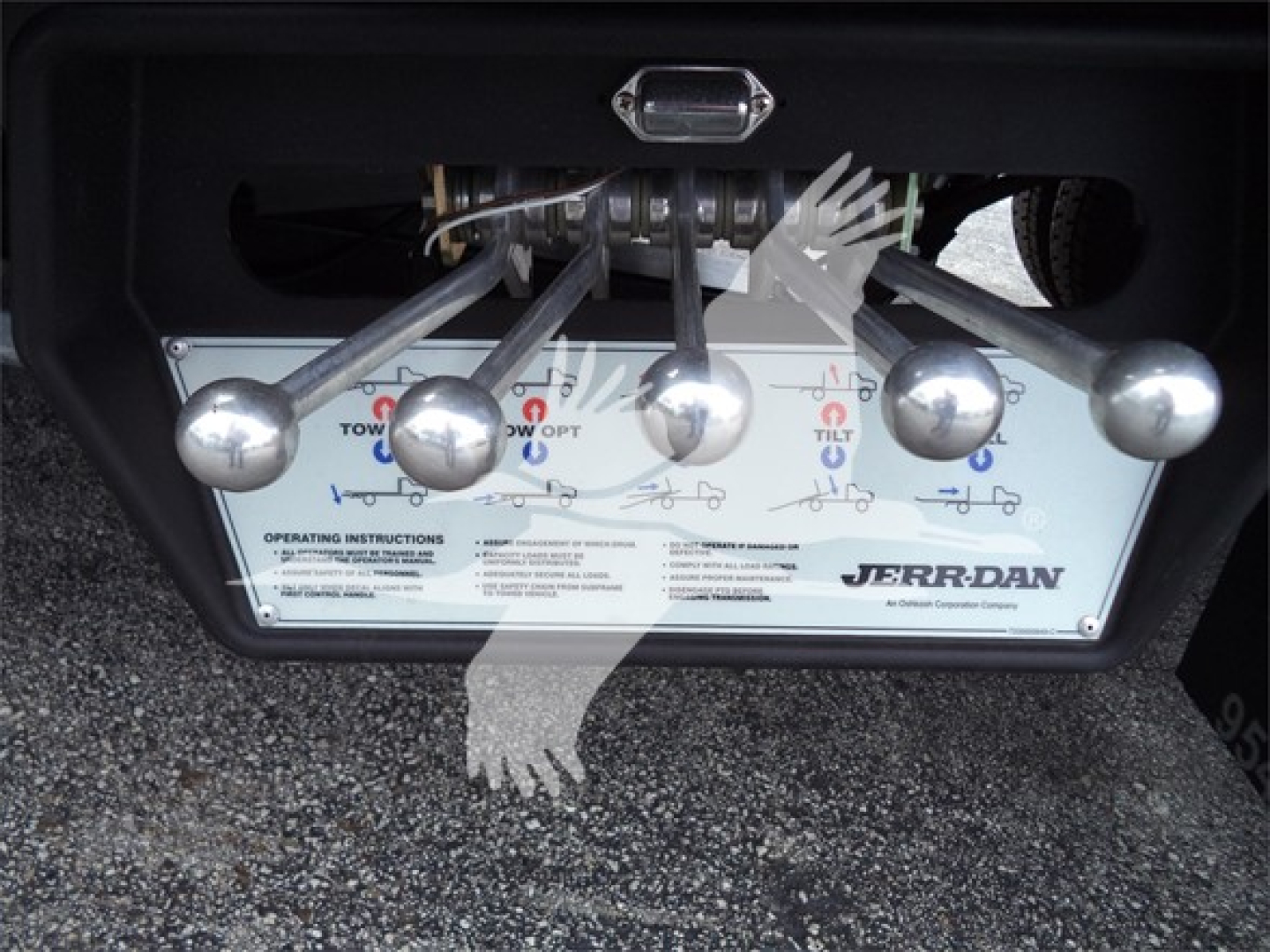 Trucks equipment panel with multiple silver levers and label showing Jerr-Dan towing control system.
