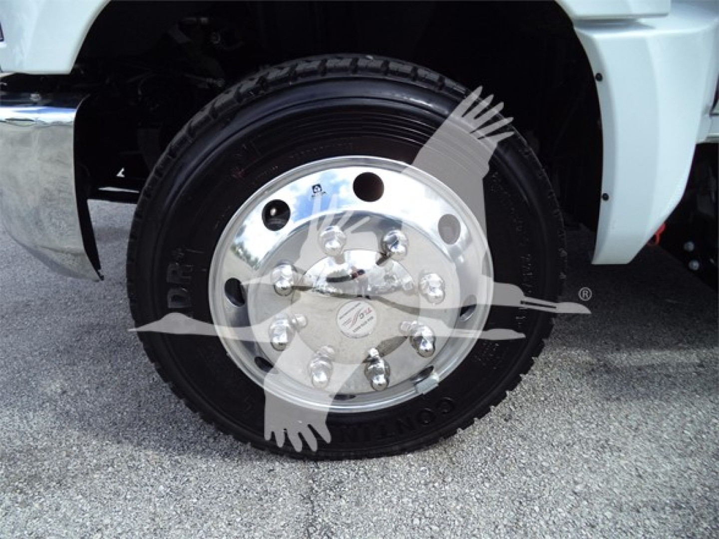 Truck wheel and tire assembly with chrome hubcap and DPF branding visible on the Silverado 6500hd rollback vehicle.