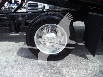 Truck wheel and cherry picker undercarriage visible with Silverado-style wheel.