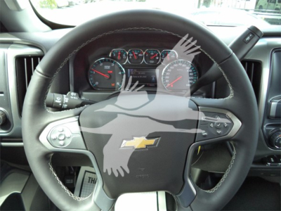 Chevrolet Silverado 6500hd steering wheel and dashboard view with Chevrolet logo center