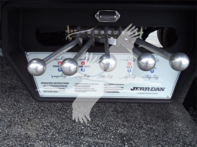Trucks equipment panel with multiple silver levers and label showing Jerr-Dan towing control system.