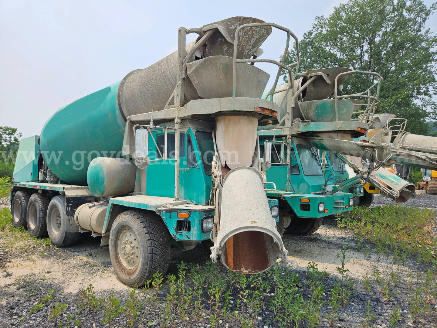 Concrete mixer truck in service showing rear discharge chute and mixer drum